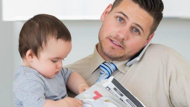 image of a man in office clothes carrying a child and cup of coffee and documents