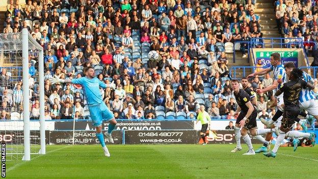 Huddersfield's Harry Toffolo powers in a header