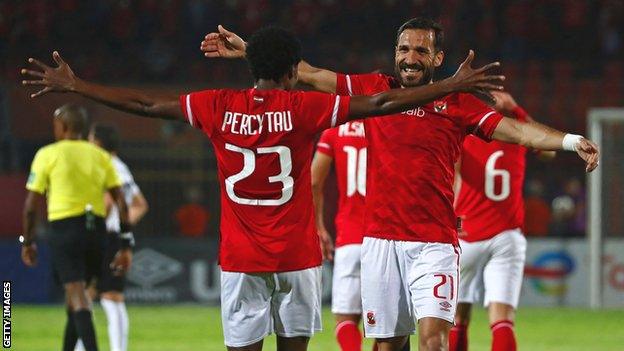 Al Ahly forward Percy Tau (left) celebrates a goal with defender Ali Maaloul