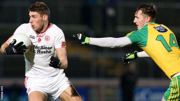 Tyrone's Padraig McNulty turns away from Donegal's Jason McGee