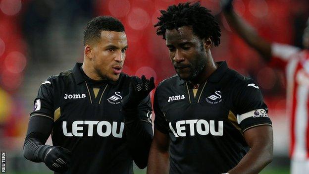 Martin Olsson talks to Swansea goal-scorer Wilfried Bony during the loss at Stoke