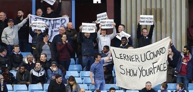 Villa fans stand to protest in the 74th minute