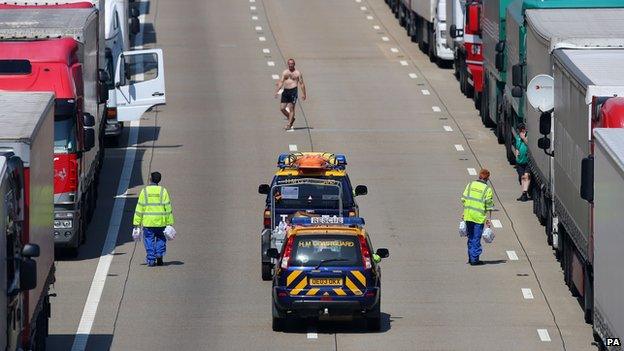 Members of the Coastguard hand out water to stranded lorry drivers on the M20