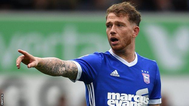 Joe Garner points towards an Ipswich team-mate