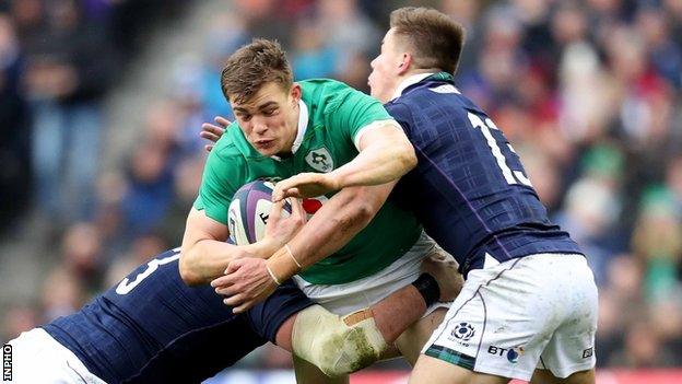 Garry Ringrose is tackled by Zander Ferguson and Huw Jones