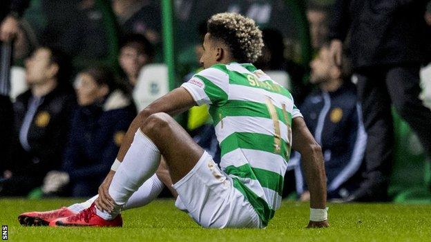 Scott Sinclair holds his left ankle