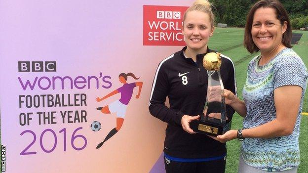 Kim Little is presented with her trophy by former USA player Shannon MacMillan