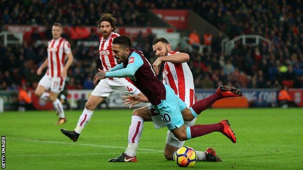 Lanzini tumbles as Stoke's Erik Pieters makes a challenge