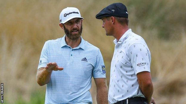 Dustin Johnson (left) and Bryson DeChambeau (right) talk during a round