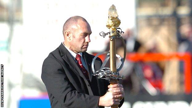 Robin McBryde with the ceremonial sword from the Royal National Eisteddfod of Wales at Ray Gravell's funeral