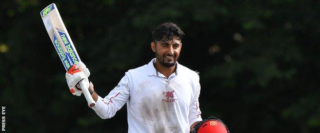 Nizakat Khan acknowledges applause after reaching his century