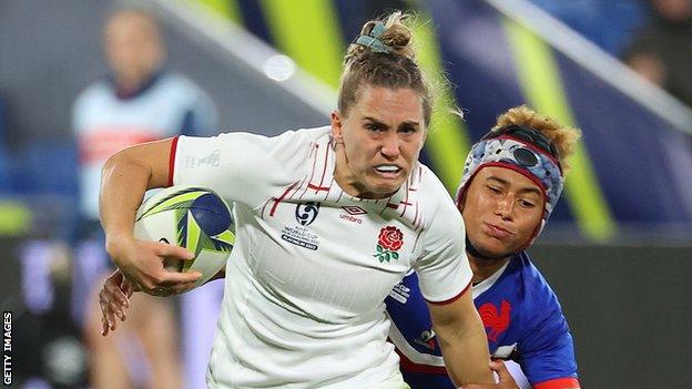 Claudia MacDonald runs with the ball