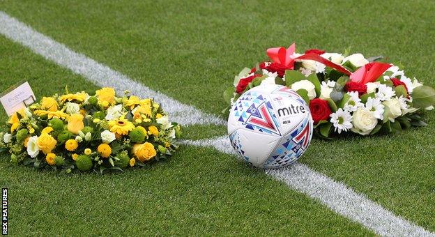 Floral tributes to Justin Edinburgh at the pre-season friendly between Leyton Orient and Norwich