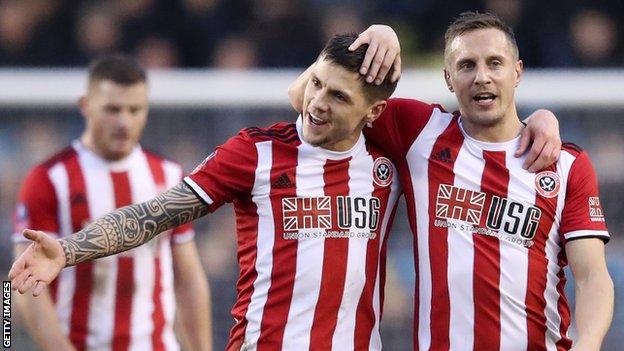 Sheffield United's Muhamed Besic celebrates with Phil Jagielka