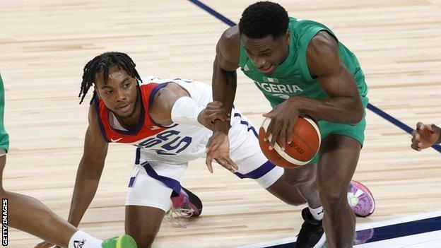 Darius Garland of the United States fouls Caleb Agada of Nigeria