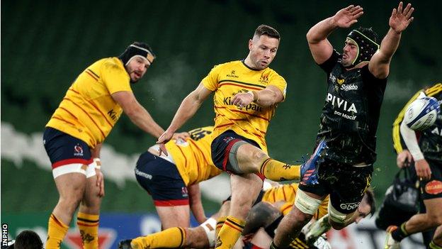 Ulster scrum-half John Cooney takes a box kick despite the efforts of La Rochelle's Gregory Alldritt