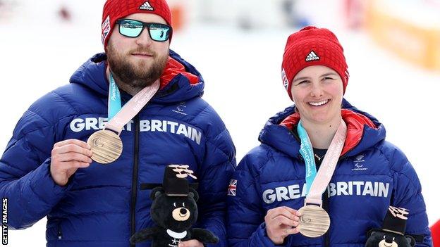 Brett Wild and Millie Knight pose with medals at the P