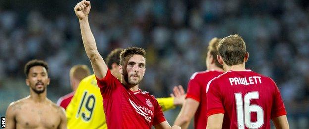 Graeme Shinnie salutes the travelling support