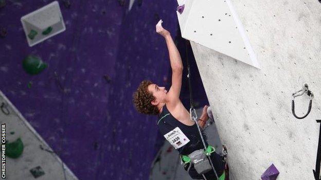 South African climber Christopher Cosser in action on a climbing wall