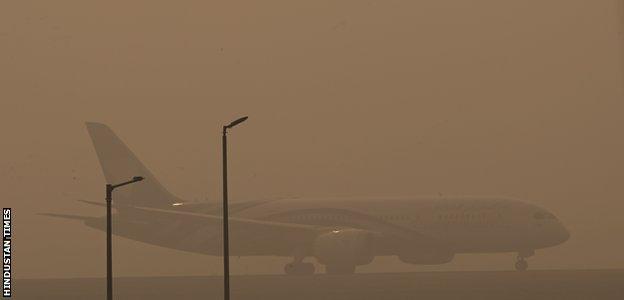 A plane sits on the runway at Delhi airport on 5 November