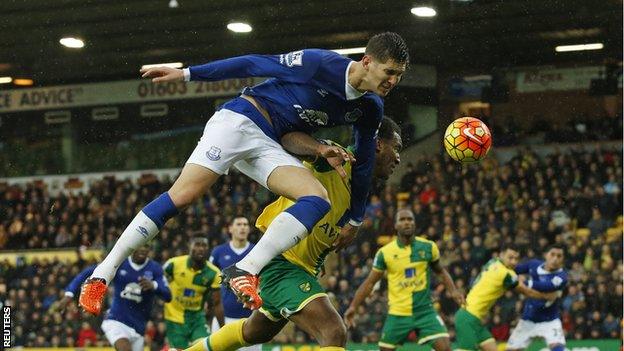 Everton defender John Stones in action with Norwich's Andre Wisdom