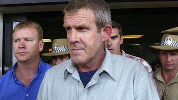 Bradley Murdoch with police at Darwin airport on 24 November 2003