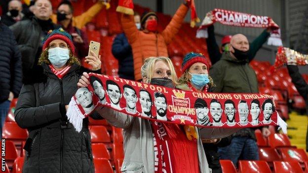 Liverpool fans hold their scarves up before kick off against Wolves