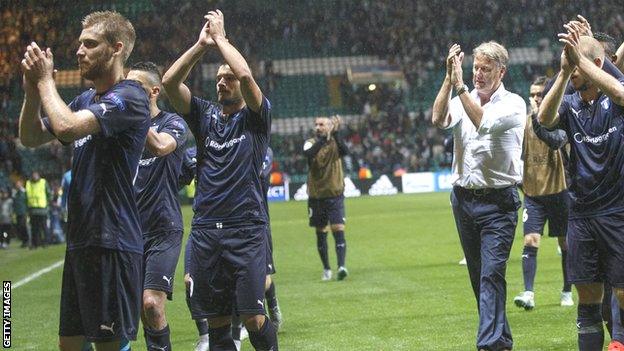 Age Hareide and his Malmo players applaud their fans at the end of the play-off first leg at Celtic Park