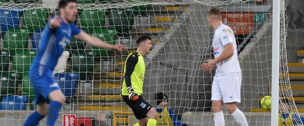 Ballymena keeper Ross Glendinning can only watch on as Cormac Burke's shot hits the net