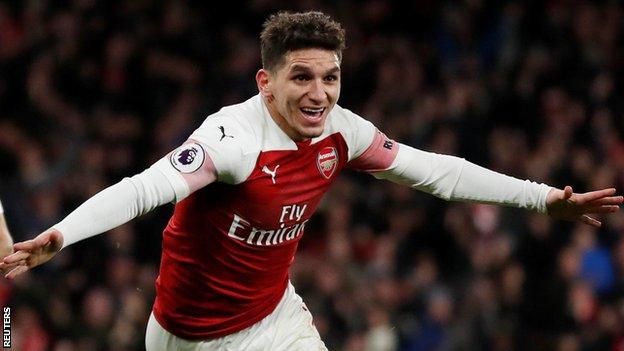 Arsenal midfielder Lucas Torreira spreads his arms wide in celebration after scoring the winner against Huddersfield