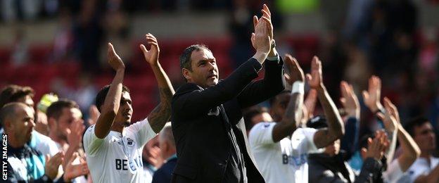 Paul Clement (centre) and Swansea players applaud the fans