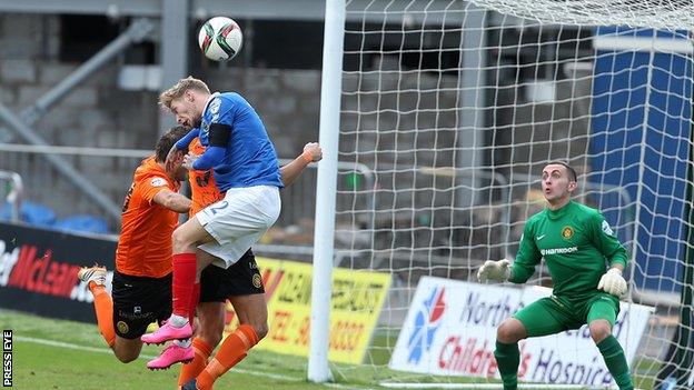 Linfield's Kirk Millar attempts to loop a header of Carrick keeper Brian Neeson