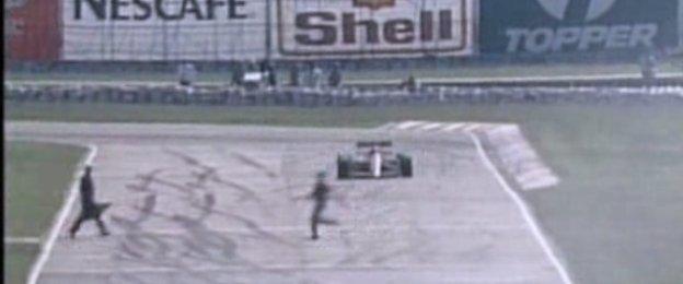 Man runs across the track at the 1989 Brazilian Grand Prix