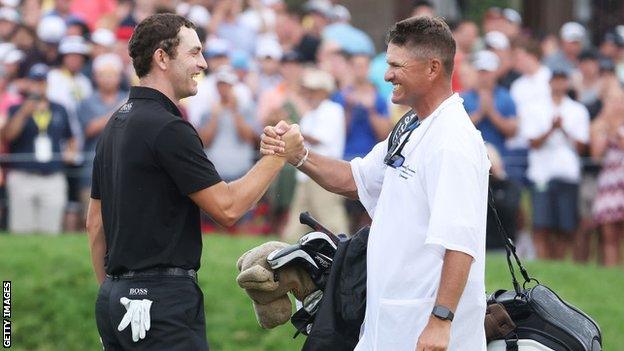 Patrick Cantlay celebrates with his caddie, Matt Minister, on the 18th after winning the Memorial Tournament in 2021