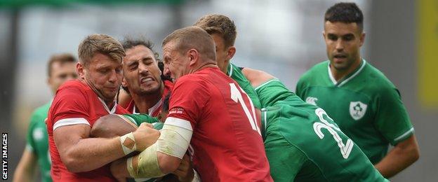 Dan Biggar, Josh Navidi and Hadleigh Parkes combine to halt the progress of Bundee Aki