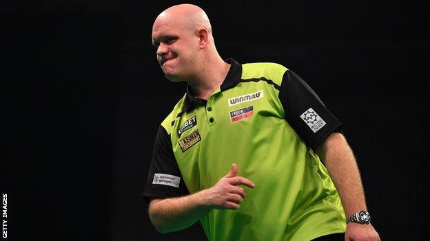 Michael van Gerwen reacts during a darts match