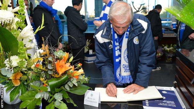 Leicester fan signs the book of condolence