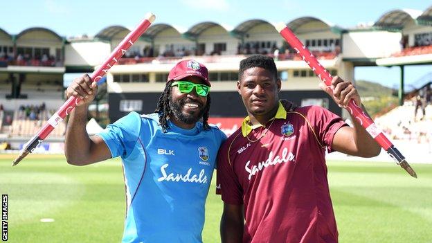 West Indies players Chris Galye (left) and Oshane Thomas (right) hold up a stump each after victory over England