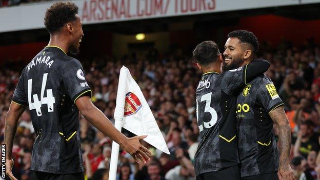 Douglas Luiz celebrates with Aston Villa team-mates after scoring at Arsenal