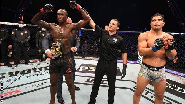 Israel Adesanya (left) celebrates his win over Paulo Costa at UFC 253