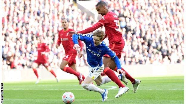 Anthony Gordon and Joel Matip tangle in the box at Anfield