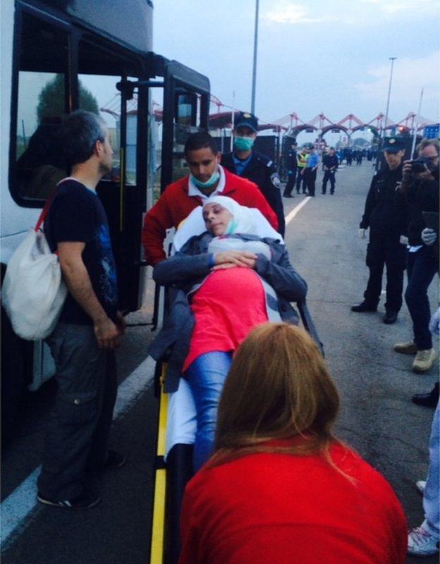 Woman being helped onto a bus