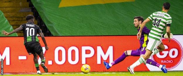 Tokmac Nguen slides in the winning goal from a tight angle at Celtic Park