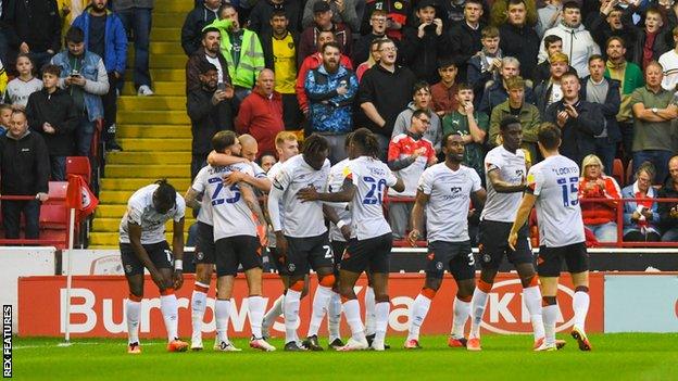 Luton players celebrate Amari'i Bell's first goal for the club