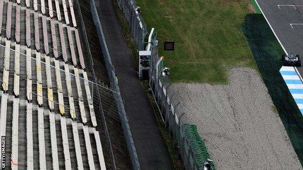 Lewis Hamilton drives past an empty grandstand during a practice session for the German Grand Prix in 2016