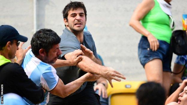 Fans fight at the Rio 2016 men's tennis competition