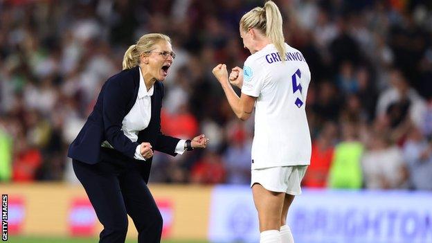 Sarina Wiegman celebrates on the pitch