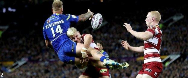 Warrington's Joe Westerman is tackled by Wigan's George Williams