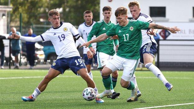 Scotland's Adam Montgomery and NI striker Chris McKee vie for the ball at Blanchflower Stadium