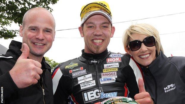 Peter Hickman (centre) with Ryan Farquhar and the KMR boss' wife Karen after finishing third in the Lightweight Supertwins race at last year's Isle of Man TT